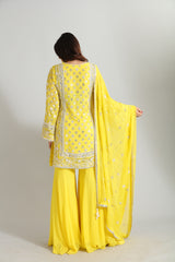 Crafted in luminous yellow georgette, this ensemble glows with intricate Gotta Patti and hand embroidery